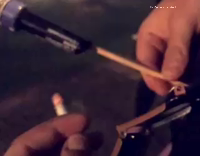 Guy lights firework with cigarette