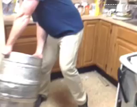 man destroys stove with keg