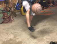 Guy kicks up basketball and balances it on foot