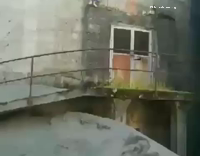 White Shirt Barefoot Standing On Silo Side Flips Into Pile of Dirt