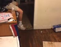 Black Shirt Slides Across Wet Wooden Floor