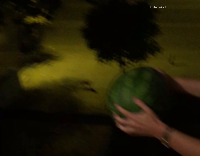 Guy head butts watermelon and leaves a small dent