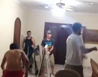 Bunch of guys flipping chairs tables room with sticks