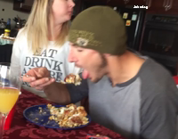 people eating and dog looking from outside of the window