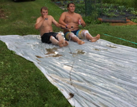 Two Guys Dragged on Slip and Slide Crash Into Group Bowling