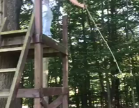 long haired man rope swing