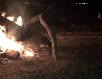 guy walks toward fire pit 