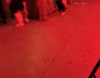 Short hair blonde girl jumping at bar to music