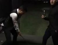 Guy hits golfball off friends foot