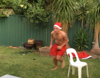 Shirtless Santa Hat Slides Across White Table Into Another White Table