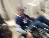 guy riding wheelchair and falling down