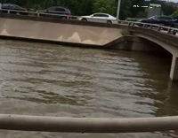 Man Rides A Jet Ski Under Bridges and Cars In A Flooded Reservoir