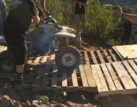 Four Wheeler Goes Off Wooden Pallets Into Shirtless Guys