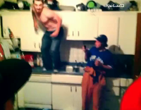 Shirtless Guy Drops Elbow on Kitchen Table