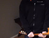 man crushes guitar on head