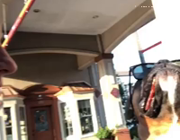 dog wearing glasses and having bacon in the side of his mouth