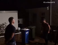 Small man kicks tall man in black