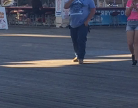 man on boardwalk falls ice cream
