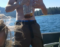 Guy Drinking From Bottle of Alchohol Falls Backwards Out of Moving Boat