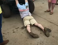 Guy Dragged Behind Green Utility Cart