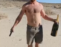 Shirtless Man Shoots Large Bottle of Champaign in his Hand Says 'that didnt work'